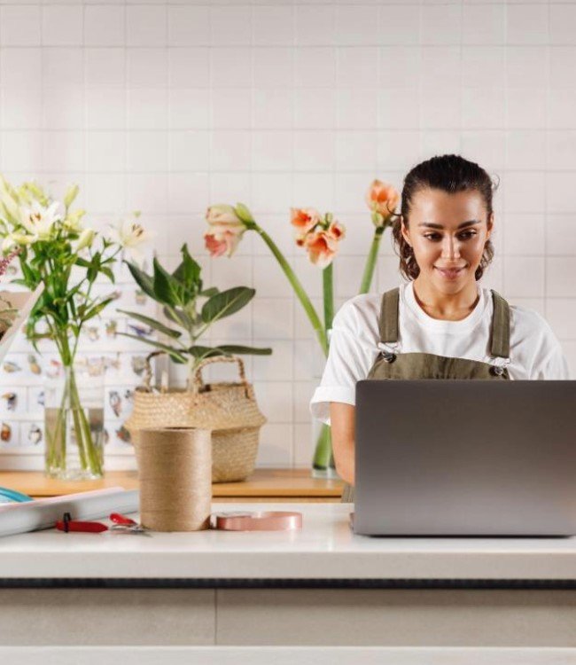 Woman at computer small plant business
