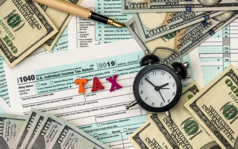 Clock, money, and work papers on a table