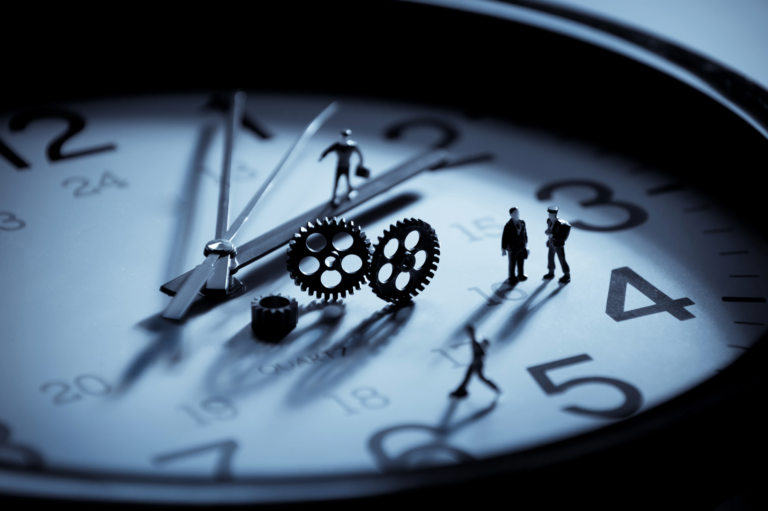 Clock with miniature people walking on the clock hands