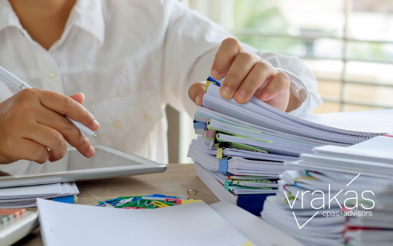 Person sorting through paperwork on their desk
